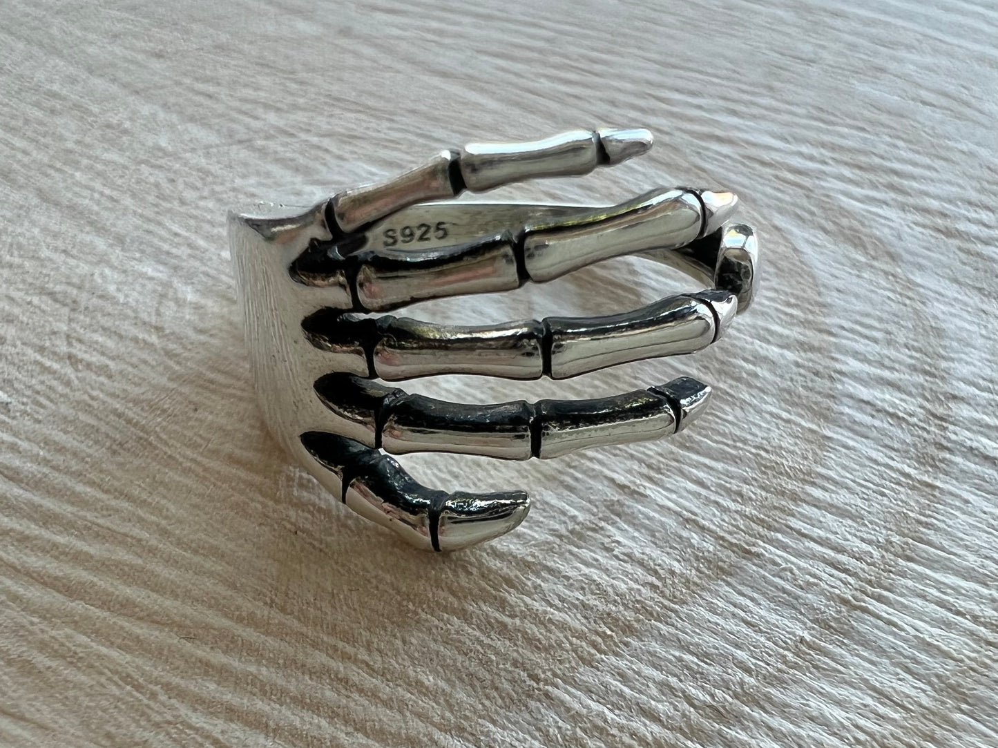 Silver skeleton hand ring